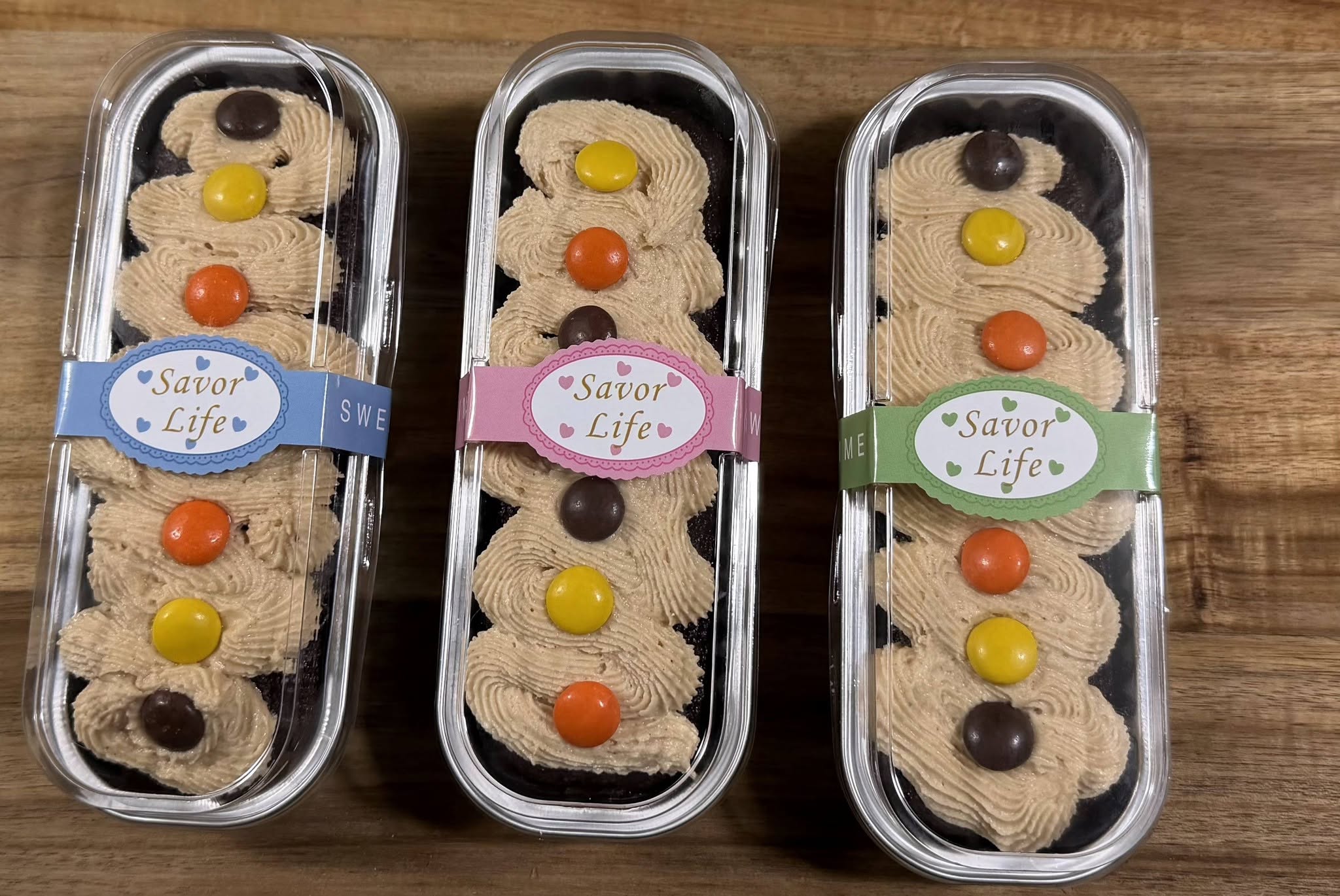 Mini desserts finished with swirled topping and colorful candy